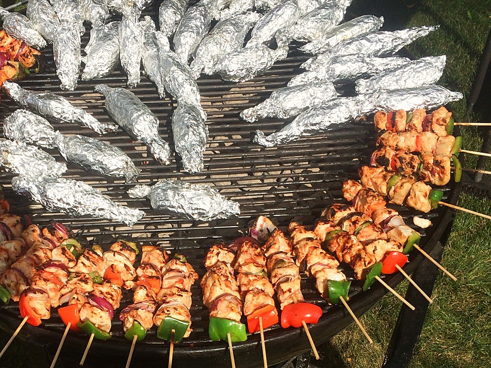 Marinated kabobs and grill packs over the fire
