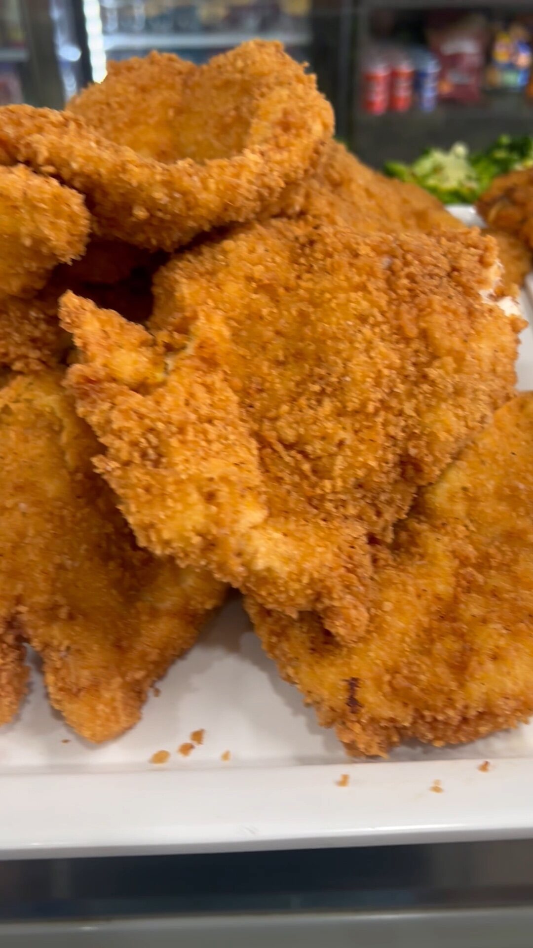 A tray of breaded chicken cutlets, ready to heat and serve